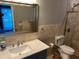 Bathroom featuring a marble countertop, vanity with updated fixtures, and tiled shower at 1534 25Th St, Sarasota, FL 34234
