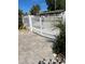 Exterior shot of a home's white picket fence with a paver pathway at 1534 25Th St, Sarasota, FL 34234