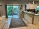 Kitchen with breakfast bar and granite countertops overlooking the landscaped backyard at 1534 25Th St, Sarasota, FL 34234