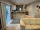 Open-concept kitchen with bar seating area flowing to living room and sliding door leading to backyard at 1534 25Th St, Sarasota, FL 34234