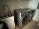 Modern laundry room with washer, dryer, and utility sink at 1534 25Th St, Sarasota, FL 34234