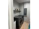 Well-lit laundry room with shelving and modern, front-loading washer and dryer units at 1534 25Th St, Sarasota, FL 34234