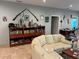 Comfortable living room featuring a bookshelf, unique decor, and a cozy sectional sofa at 1534 25Th St, Sarasota, FL 34234