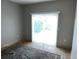 Bright living room featuring neutral walls, tile flooring, and sliding glass doors at 1534 25Th St, Sarasota, FL 34234
