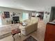 Bright living room featuring a large leather sofa, decorative rug and seamless access to the modern kitchen at 1534 25Th St, Sarasota, FL 34234
