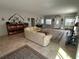 Bright, open-concept living room with tile flooring, comfortable seating, and access to multiple rooms at 1534 25Th St, Sarasota, FL 34234