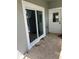Back patio featuring neutral pavers, a sliding glass door to kitchen, and rear entry door at 1534 25Th St, Sarasota, FL 34234