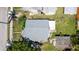 An aerial view shows the roof and surrounding yard with partial fence on a sunny day at 1704 Ballard Park Dr, Bradenton, FL 34205