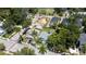 An aerial view of the property outlined in yellow, showcasing its location among lush greenery and neighboring homes at 1704 Ballard Park Dr, Bradenton, FL 34205