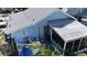 Rear exterior showcasing the light blue siding, screened porch, and fenced yard at 1704 Ballard Park Dr, Bradenton, FL 34205
