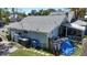 Rear exterior showcasing the light blue siding, screened porch, and fenced yard at 1704 Ballard Park Dr, Bradenton, FL 34205