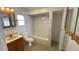 Bright bathroom featuring a tiled shower-tub combo, classic vanity, and ceramic tile flooring at 1704 Ballard Park Dr, Bradenton, FL 34205