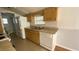 Functional kitchen with wood cabinets, tile flooring, and essential appliances at 1704 Ballard Park Dr, Bradenton, FL 34205