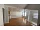 Open-concept living area with hardwood floors, leading to the kitchen and entryway at 1704 Ballard Park Dr, Bradenton, FL 34205