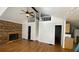 Bright living room featuring a vaulted ceiling, fireplace and a unique loft space at 1704 Ballard Park Dr, Bradenton, FL 34205