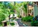 Secluded backyard featuring lush greenery, a covered patio, and comfortable lounge seating at 1739 Oak St, Sarasota, FL 34236