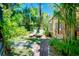 Lush backyard featuring a covered patio, manicured landscaping, and inviting lounge chairs at 1739 Oak St, Sarasota, FL 34236