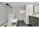 Renovated bathroom features a walk-in shower with subway tiles and modern vanity at 1739 Oak St, Sarasota, FL 34236