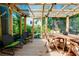 Charming covered patio featuring a wooden deck, comfortable seating, and a serene outdoor ambiance at 1739 Oak St, Sarasota, FL 34236