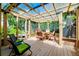 Inviting covered patio with wooden deck, comfortable seating, and lush green surroundings at 1739 Oak St, Sarasota, FL 34236