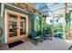 Cozy covered patio featuring a seating area, a wooden deck, and seamless indoor-outdoor flow at 1739 Oak St, Sarasota, FL 34236