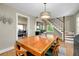 This dining room has an elegant light fixture and offers access to the stairs and natural light at 1739 Oak St, Sarasota, FL 34236