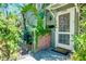 Charming home entrance featuring lush landscaping, brick accents, and a welcoming front door at 1739 Oak St, Sarasota, FL 34236