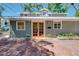 Charming home featuring a brick walkway, stylish planters, and unique architectural details at 1739 Oak St, Sarasota, FL 34236