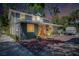 Inviting home featuring a paved driveway, lush greenery and exterior lighting at 1739 Oak St, Sarasota, FL 34236