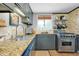 This kitchen has granite countertops, stainless steel appliances, and access to lots of natural light at 1739 Oak St, Sarasota, FL 34236