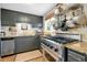 This kitchen has granite countertops, stainless steel appliances, and a pot rack at 1739 Oak St, Sarasota, FL 34236