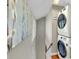Functional laundry area with stacked washer and dryer units, complemented by stylish wall art at 1739 Oak St, Sarasota, FL 34236