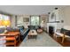 Spacious living room with a fireplace, leather sofa, and hardwood floors at 1739 Oak St, Sarasota, FL 34236