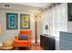 Cozy living room nook featuring a chair, dresser, and unique art decor at 1739 Oak St, Sarasota, FL 34236