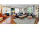 Open living room with hardwood floors, a leather sofa, and a cozy atmosphere at 1739 Oak St, Sarasota, FL 34236