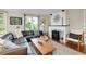 Bright and airy living room featuring a leather sofa, fireplace, and natural light at 1739 Oak St, Sarasota, FL 34236