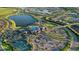 Stunning aerial view of the community featuring lakes, a clubhouse, tennis courts, and lush landscaping at 17440 Hampton Falls Ter, Bradenton, FL 34202