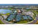 Aerial view of community tennis courts, landscaping, lakes, clubhouse, parking, and surrounding residential area at 17440 Hampton Falls Ter, Bradenton, FL 34202