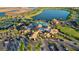 Breathtaking aerial shot of the community clubhouse, featuring a swimming pool, lake, and surrounding greenery at 17440 Hampton Falls Ter, Bradenton, FL 34202