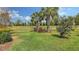 Expansive backyard featuring well manicured lawn, mature trees, and rod iron fencing at 17440 Hampton Falls Ter, Bradenton, FL 34202
