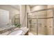 Bathroom with a single sink, granite countertop, wood cabinet, and walk-in shower at 17440 Hampton Falls Ter, Bradenton, FL 34202