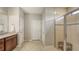 Bathroom with tile floors, white doors, walk in shower and double vanity at 17440 Hampton Falls Ter, Bradenton, FL 34202