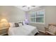 Cozy bedroom featuring a ceiling fan, side table with lamp and plantation shutters at 17440 Hampton Falls Ter, Bradenton, FL 34202