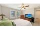 Comfortable bedroom with wood flooring, a ceiling fan and bright windows at 17440 Hampton Falls Ter, Bradenton, FL 34202