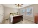 Comfortable bedroom featuring wood flooring, a ceiling fan, and bright windows with natural light at 17440 Hampton Falls Ter, Bradenton, FL 34202