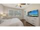 Bedroom with hardwood floors and a dresser with a TV at 17440 Hampton Falls Ter, Bradenton, FL 34202