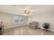 Bonus room featuring a recliner chair, a ceiling fan, and window with a wooden blind at 17440 Hampton Falls Ter, Bradenton, FL 34202