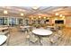 Elegant dining room features ample seating arrangements, large windows, and modern lighting fixtures at 17440 Hampton Falls Ter, Bradenton, FL 34202