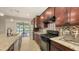 The kitchen has a large granite island and stainless appliances with nice wood cabinets at 17440 Hampton Falls Ter, Bradenton, FL 34202