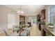 Well-appointed kitchen with granite countertops, dark wood cabinets, stainless steel appliances, and a cozy dining area at 17440 Hampton Falls Ter, Bradenton, FL 34202